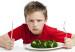 Boy not happy about eating vegetables