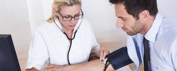 Doctor taking a patients blood pressure