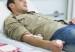 patient lying on a bed giving blood