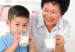 boy and grandmother drinking milk