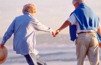 elderly couple walking at beach, ageing