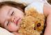 little child with teddy bear sleeping