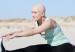 young woman with bald head doing sports after enduring chemotherapy