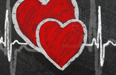 Heart beat and heart drawn on blackboard