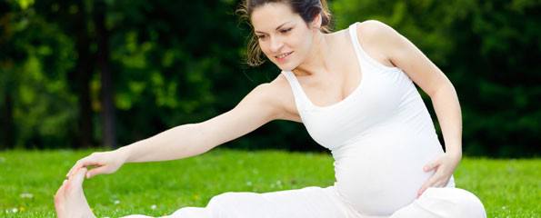pregnant woman exercising outdoors
