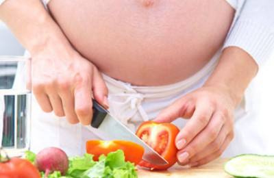 pregnant woman preparing food