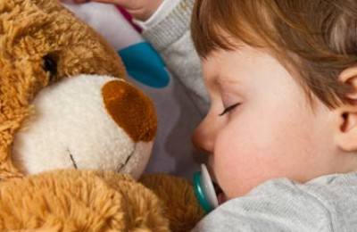 little child with teddy bear sleeping