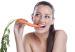 Woman eating carrot